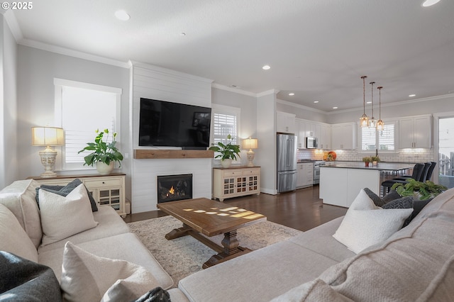 12339 SW Waterford Loop, Wilsonville, OR 97070 - living area featuring recessed lighting, crown molding, dark wood-type flooring, and a fireplace