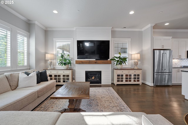 12339 SW Waterford Loop, Wilsonville, OR 97070 - living area with dark wood finished floors, recessed lighting, crown molding, a large fireplace, and baseboards