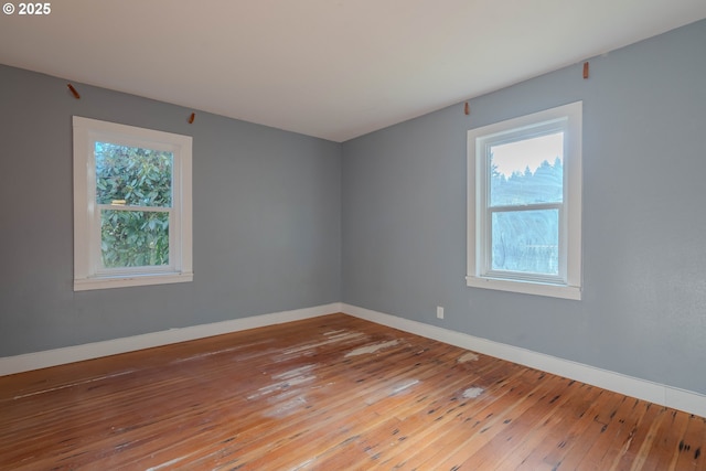 unfurnished room featuring hardwood / wood-style flooring