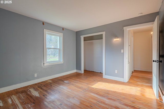 unfurnished bedroom featuring a closet and light hardwood / wood-style flooring