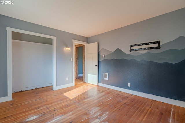 unfurnished bedroom featuring light hardwood / wood-style flooring and a closet