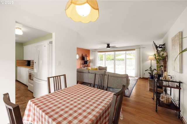 dining room featuring wood finished floors and a ceiling fan