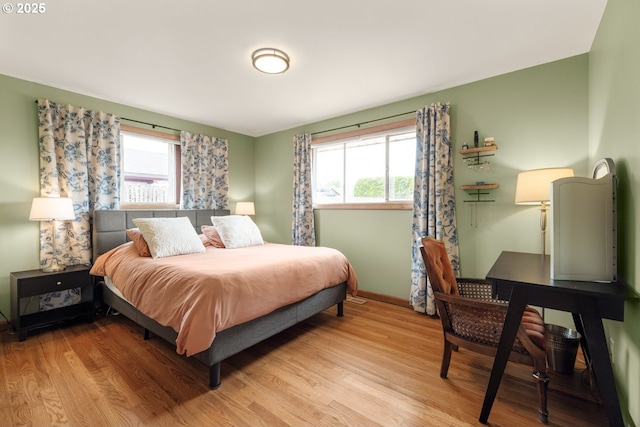 bedroom featuring light wood-style flooring and baseboards