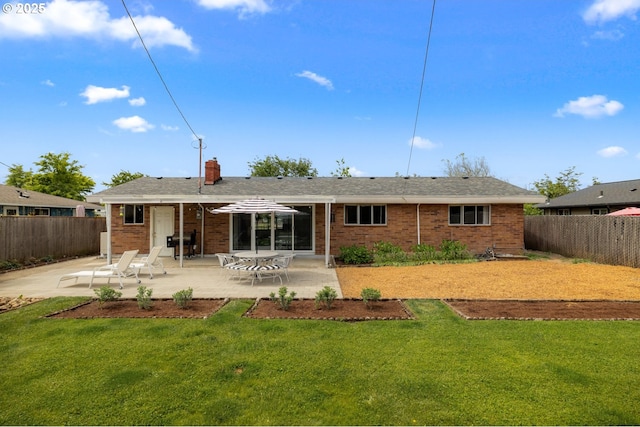 back of house with a patio, brick siding, and a chimney