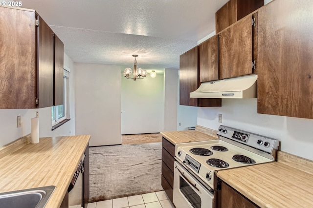 12632 NW Barnes Rd Unit 7, Portland, OR 97229 - kitchen with white range with electric cooktop, under cabinet range hood, a chandelier, a textured ceiling, and pendant lighting