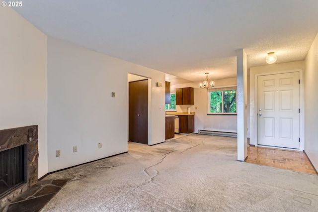 12632 NW Barnes Rd Unit 7, Portland, OR 97229 - unfurnished living room with a baseboard heating unit, a chandelier, a premium fireplace, and light colored carpet