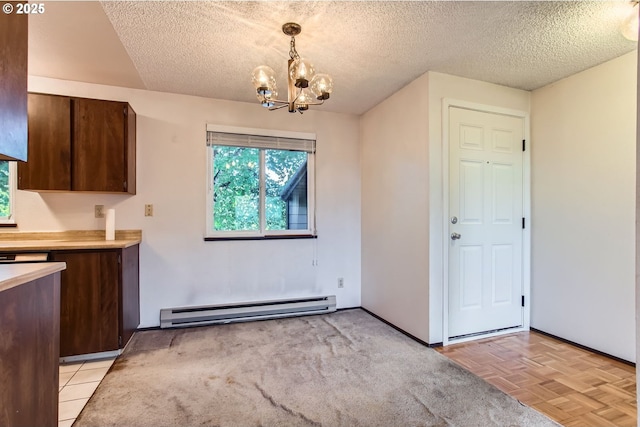 12632 NW Barnes Rd Unit 7, Portland, OR 97229 - unfurnished dining area featuring a baseboard radiator, a textured ceiling, and a chandelier