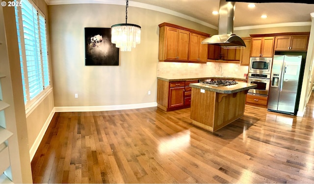 2107 NW Village Cir, Portland, OR 97229 - kitchen with appliances with stainless steel finishes, brown cabinets, ornamental molding, a center island, and light wood-style floors