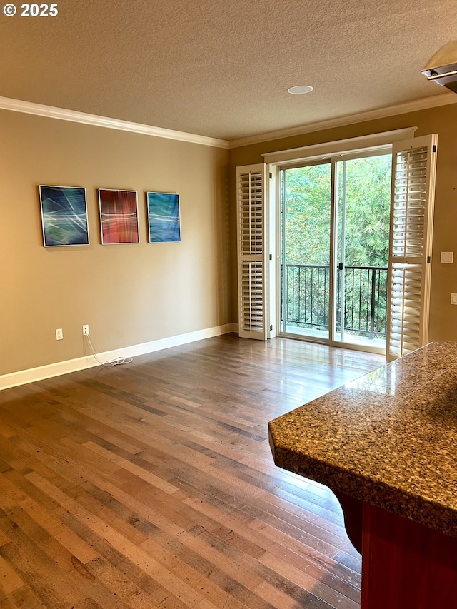 2107 NW Village Cir, Portland, OR 97229 - unfurnished living room featuring ornamental molding, hardwood / wood-style flooring, baseboards, and a textured ceiling