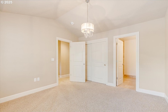 2107 NW Village Cir, Portland, OR 97229 - unfurnished bedroom with carpet, a chandelier, baseboards, a closet, and vaulted ceiling
