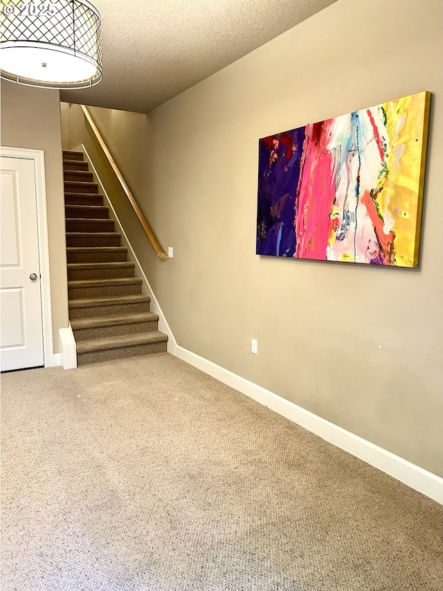 2107 NW Village Cir, Portland, OR 97229 - stairway with carpet floors, baseboards, and a textured ceiling