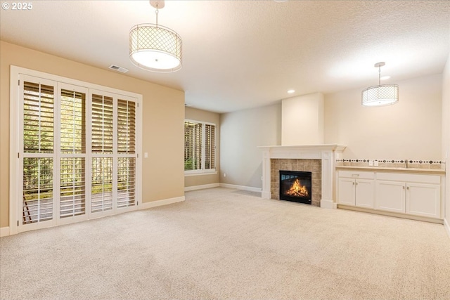 2107 NW Village Cir, Portland, OR 97229 - unfurnished living room featuring carpet flooring, a tiled fireplace, baseboards, and recessed lighting