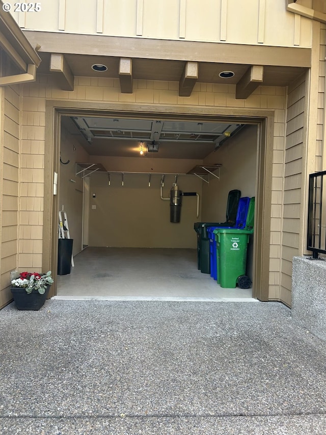 2107 NW Village Cir, Portland, OR 97229 - garage with a central vacuum unit, a garage door opener, and driveway
