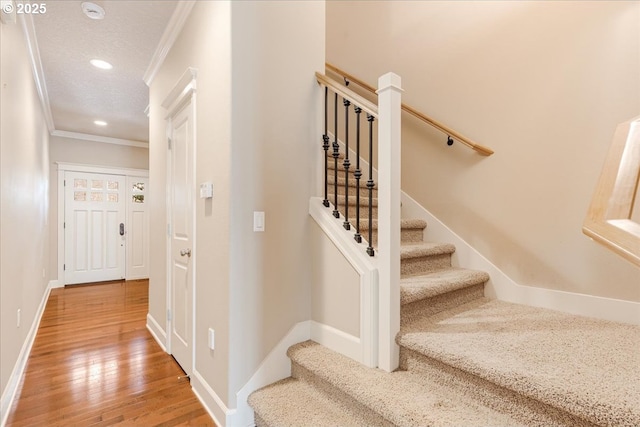 2107 NW Village Cir, Portland, OR 97229 - stairway featuring crown molding, wood finished floors, recessed lighting, baseboards, and a textured ceiling