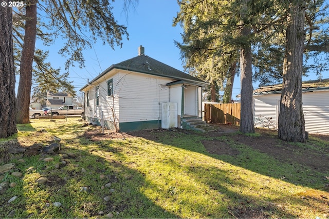 back of house with a lawn