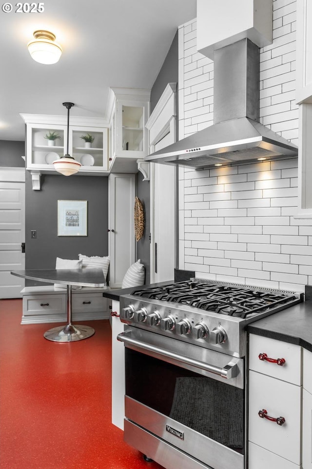 2517 NE 21st Ave, Portland, OR 97212 - kitchen featuring wall chimney exhaust hood, high end stainless steel range oven, tasteful backsplash, white cabinets, and dark countertops