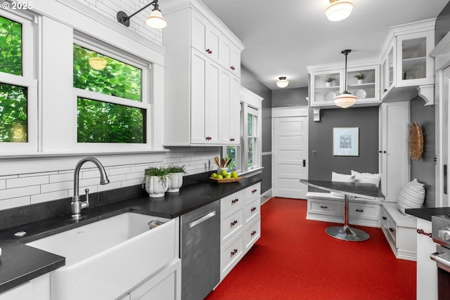 2517 NE 21st Ave, Portland, OR 97212 - kitchen with dishwasher, tasteful backsplash, dark countertops, and white cabinetry