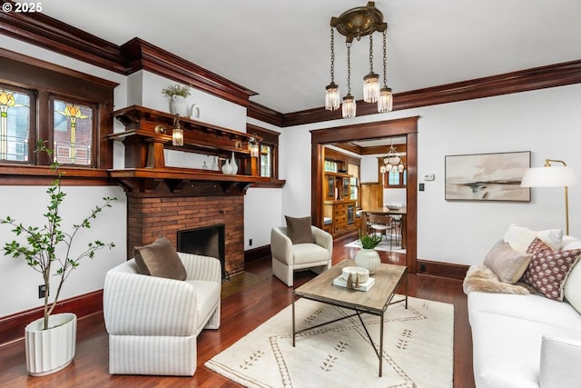 2517 NE 21st Ave, Portland, OR 97212 - living area with crown molding, wood finished floors, a chandelier, and a brick fireplace