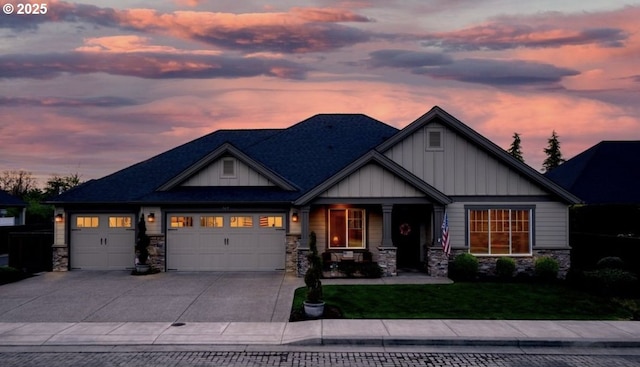 view of front of home featuring a garage, stone siding, board and batten siding, and concrete driveway