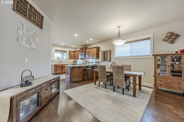 dining space featuring baseboards, dark wood-style flooring, and recessed lighting