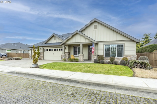 craftsman inspired home with board and batten siding, concrete driveway, fence, and stone siding