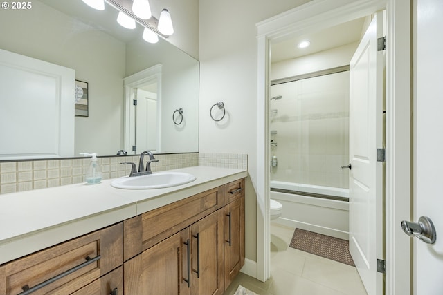 bathroom featuring toilet, backsplash, vanity, and tile patterned floors