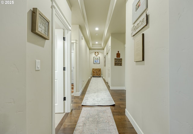 hallway featuring dark wood-style floors, baseboards, crown molding, and recessed lighting