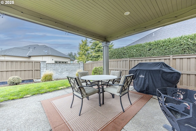 view of patio with a fenced backyard, area for grilling, and outdoor dining space