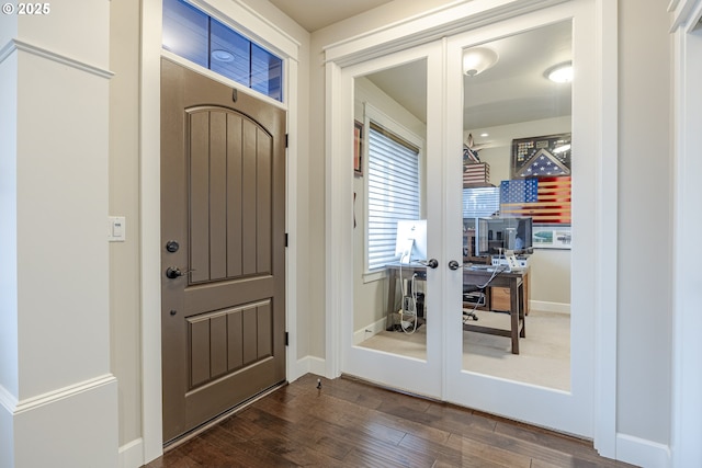 entrance foyer featuring french doors, dark wood-style flooring, and baseboards