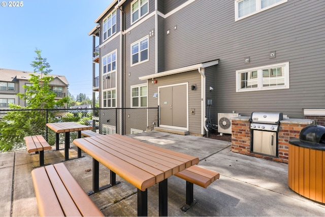 17182 SW Appledale Rd Unit 302, Beaverton, OR 97007 - view of patio featuring washer / dryer, outdoor dining space, and an outdoor kitchen