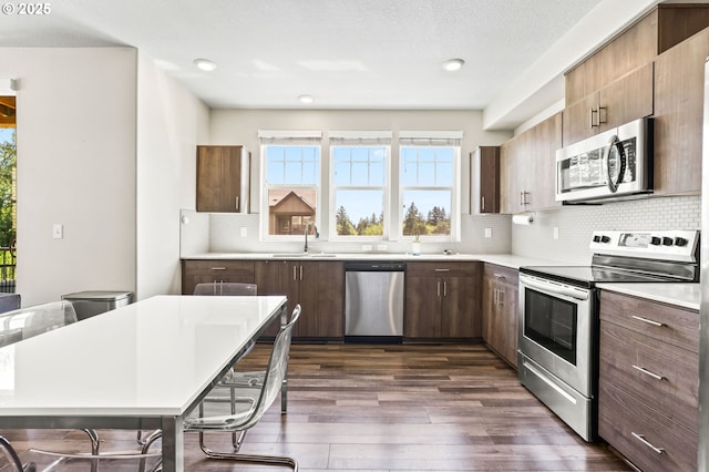 17182 SW Appledale Rd Unit 302, Beaverton, OR 97007 - kitchen with appliances with stainless steel finishes, dark wood-style floors, light countertops, plenty of natural light, and recessed lighting