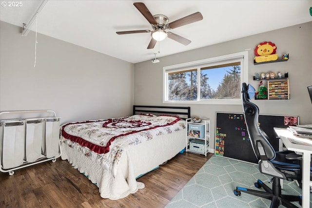 bedroom with dark hardwood / wood-style floors and ceiling fan