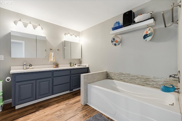 bathroom with vanity, hardwood / wood-style floors, and a bathing tub