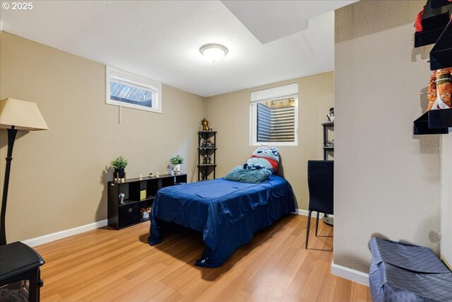 bedroom featuring wood-type flooring and a textured ceiling