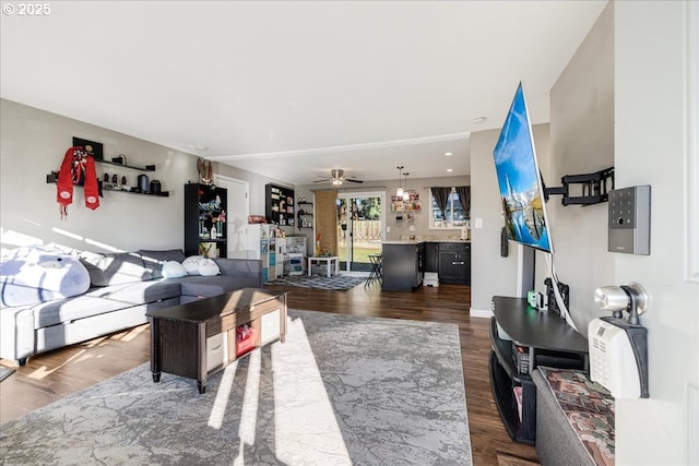 living room featuring dark hardwood / wood-style floors and ceiling fan