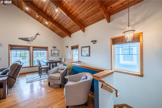 1323 Village Loop, Bandon, OR 97411 - living room with a wood ceiling with exposed beams, light wood-style floors, a chandelier, and high vaulted ceiling