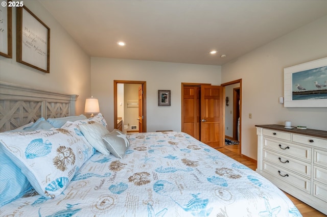 1323 Village Loop, Bandon, OR 97411 - bedroom with recessed lighting, light wood-style flooring, and ensuite bath