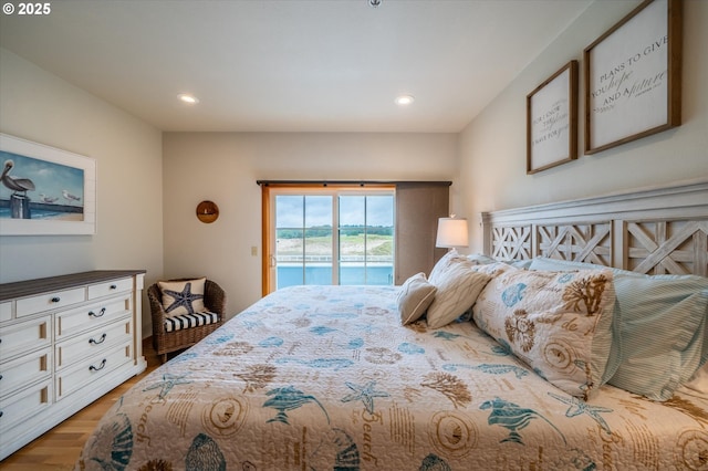 1323 Village Loop, Bandon, OR 97411 - bedroom featuring access to outside, wood finished floors, and recessed lighting