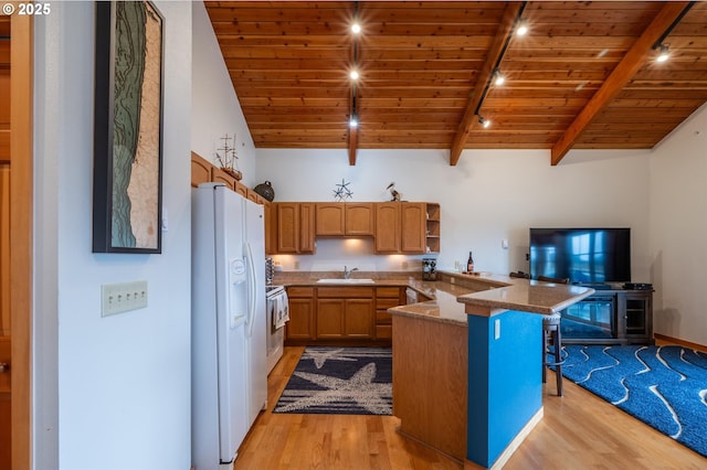 1323 Village Loop, Bandon, OR 97411 - kitchen with white appliances, light wood-type flooring, a peninsula, wood ceiling, and a breakfast bar