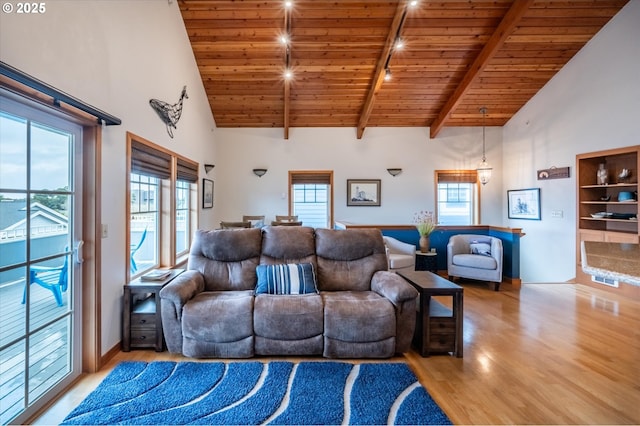 1323 Village Loop, Bandon, OR 97411 - living room with light wood-type flooring, high vaulted ceiling, and a wooden ceiling with exposed beams