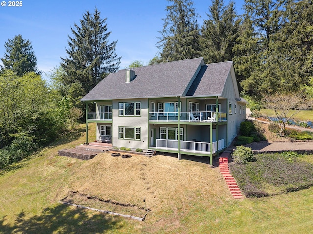 3985 Westwood Dr, Tillamook, OR 97141 - rear view of property featuring a balcony, a lawn, and a shingled roof