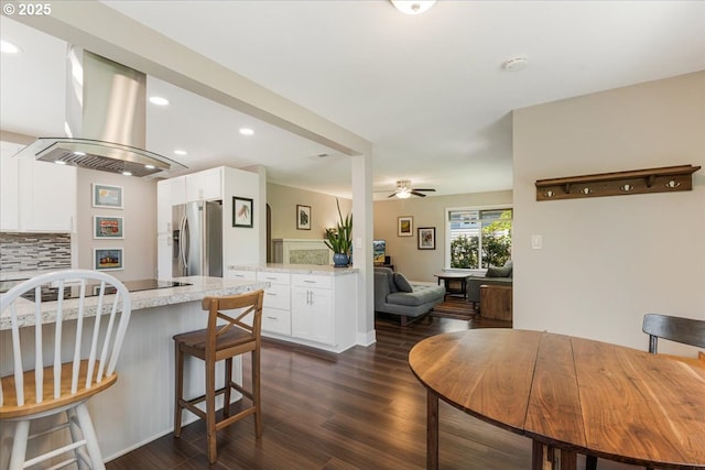 2185 Laurel Ave, Salem, OR 97301 - kitchen featuring stainless steel fridge with ice dispenser, island range hood, white cabinets, dark wood-style floors, and recessed lighting