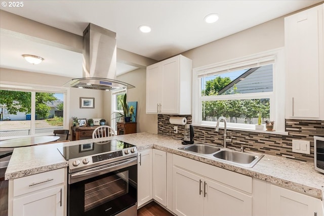 2185 Laurel Ave, Salem, OR 97301 - kitchen with stainless steel range with electric stovetop, a sink, island exhaust hood, a peninsula, and tasteful backsplash
