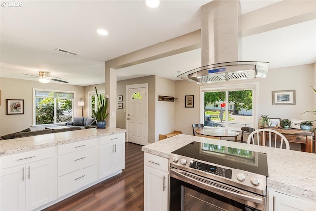 2185 Laurel Ave, Salem, OR 97301 - kitchen featuring stainless steel electric range, island exhaust hood, dark wood-style flooring, open floor plan, and white cabinets