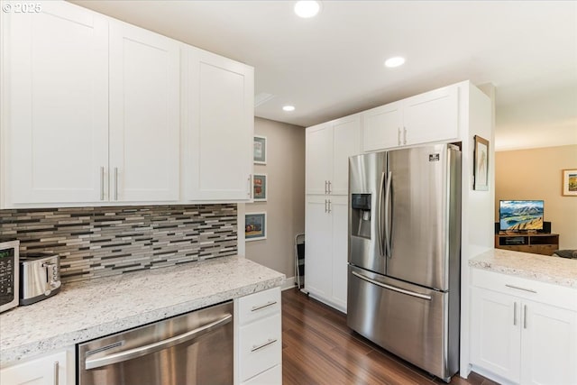 2185 Laurel Ave, Salem, OR 97301 - kitchen with stainless steel appliances, dark wood-style flooring, tasteful backsplash, white cabinetry, and recessed lighting