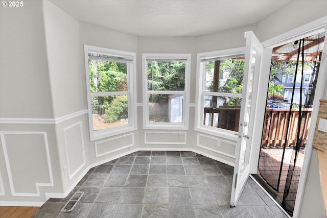 19915 SW Celebrity St, Beaverton, OR 97078 - unfurnished sunroom featuring a decorative wall, visible vents, and stone finish flooring