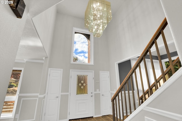 19915 SW Celebrity St, Beaverton, OR 97078 - foyer featuring a chandelier, a high ceiling, and stairs