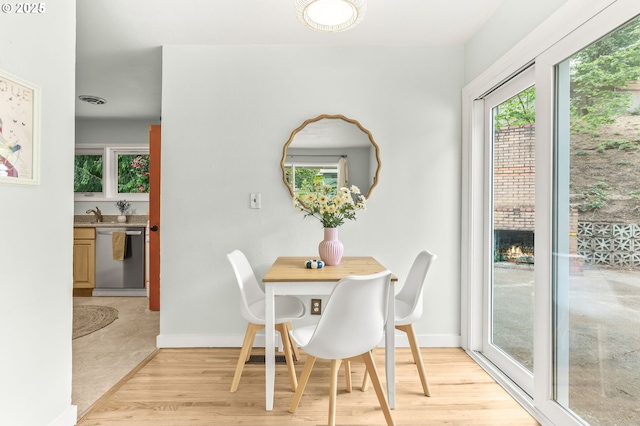 dining room with baseboards and light wood-style floors