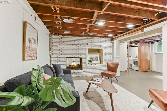 living area featuring washer / clothes dryer and concrete floors