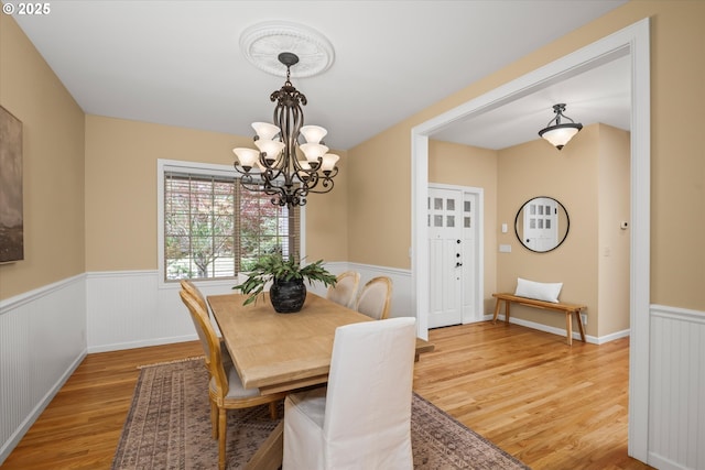 2053 Lakeview Dr, Eugene, OR 97408 - dining space featuring light wood-style floors, a chandelier, and wainscoting